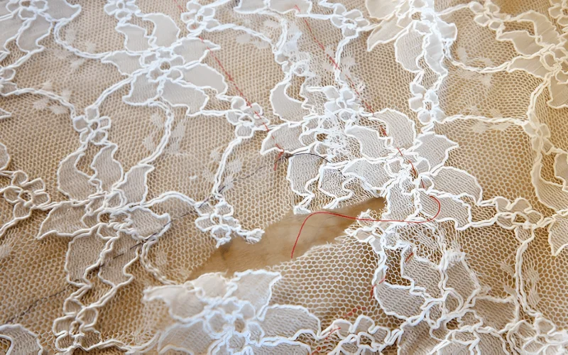 The appliques should be carefully overlapped over the seam line to camouflage the stitching, resulting in a nearly invisible seam