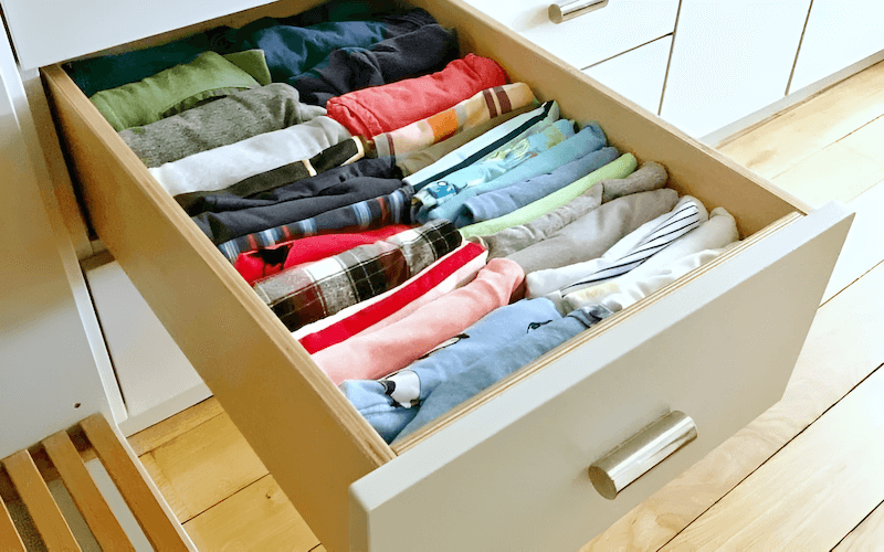 Proper folding, particularly techniques like vertical folding inspired by the KonMari method