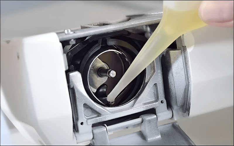 Oiling your sewing machine, which keeps everything moving smoothly and prevents wear and tear with just a few drops