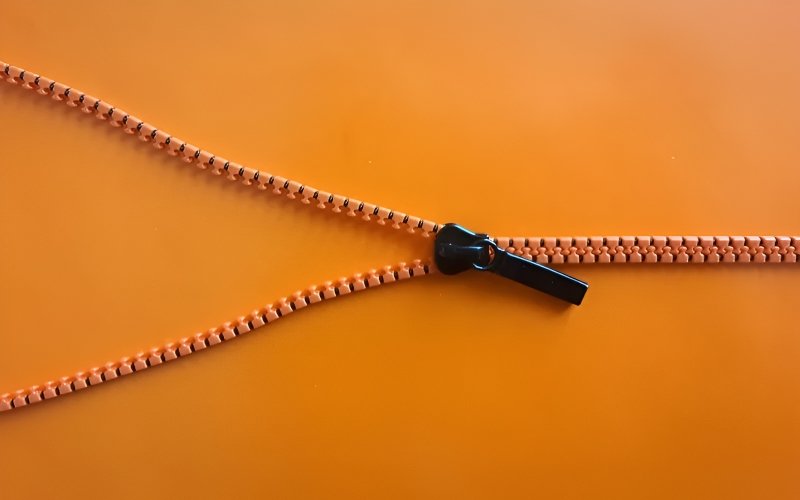 Slide the zipper slowly and steadily along the track. Avoid rushing, as this can cause the zipper to snag or misalign.