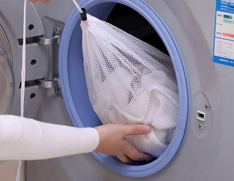 Mesh laundry bag protecting rhinestones during delicate machine wash cycle