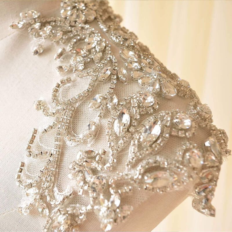 Close-up of precise rhinestone placement, expert techniques for stunning embellishments.