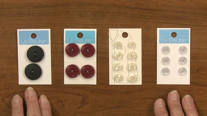 Close-up of 4-hole and 2-hole flat buttons, ready for sewing.