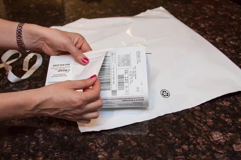 Person printing a shipping label at home for online postage