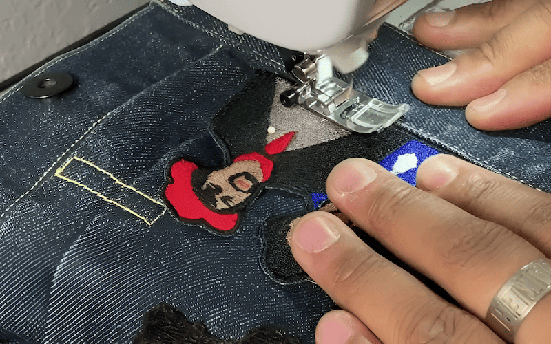 Thread a needle with a thread color that matches the patch border or the denim