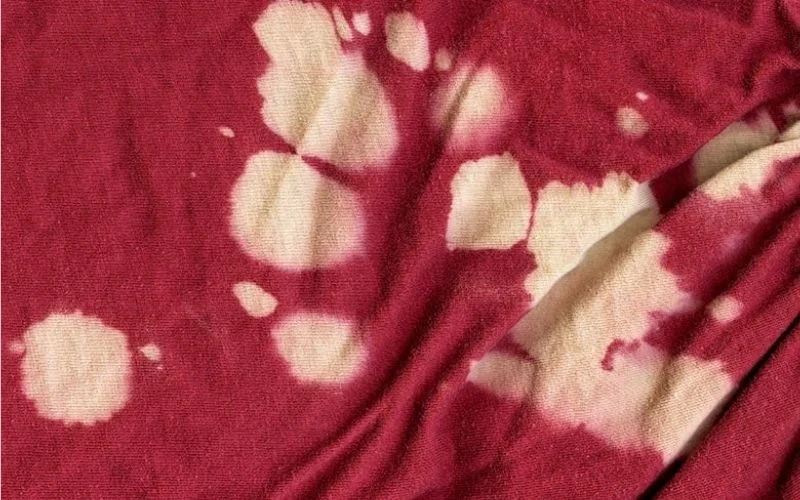 Pouring Undiluted Bleach directly onto dry fabrics causes concentrated spots of intense whitening or damage