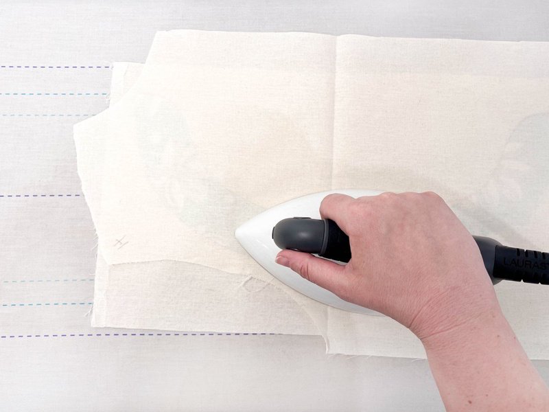 Apply fusible interfacing with press cloth, heat, pressure.