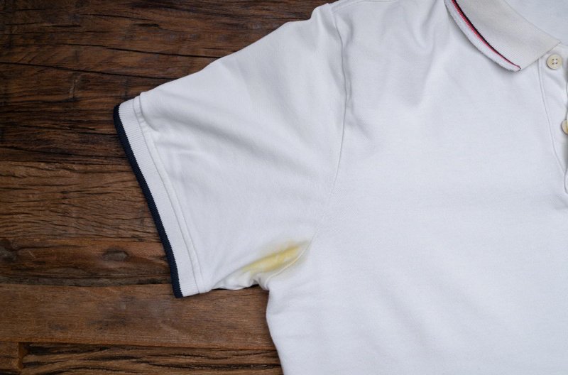 Sweat reacts with deodorant chemicals, causing yellow stains.