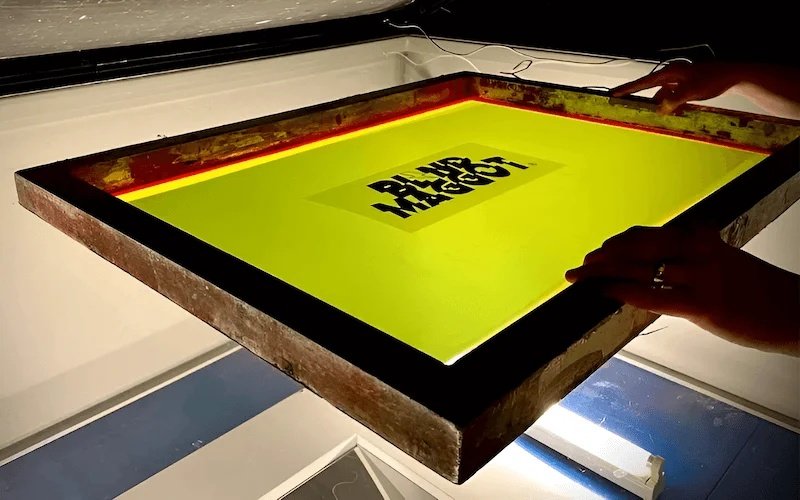 A clean, framed mesh screen is evenly coated with light-sensitive photo emulsion.