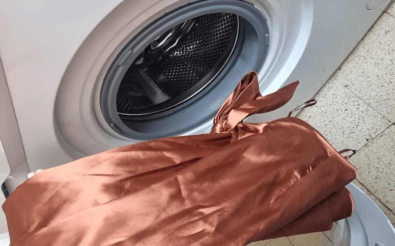 Machine washing is generally riskier than hand washing for silk