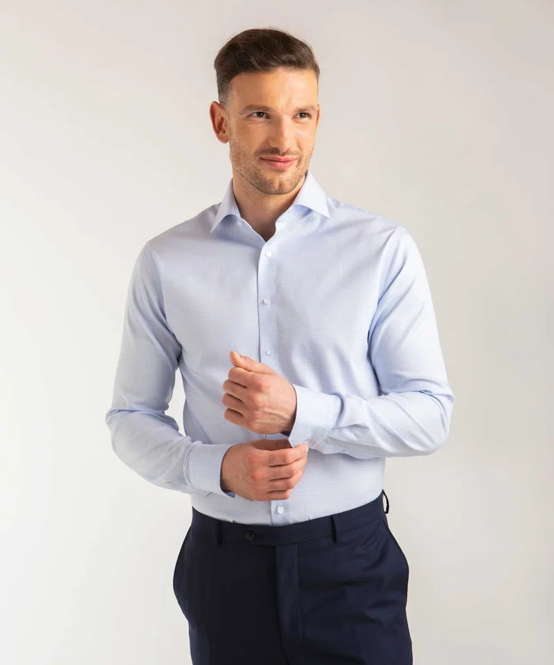 Dress shirt sleeves should end precisely at wrist bone.