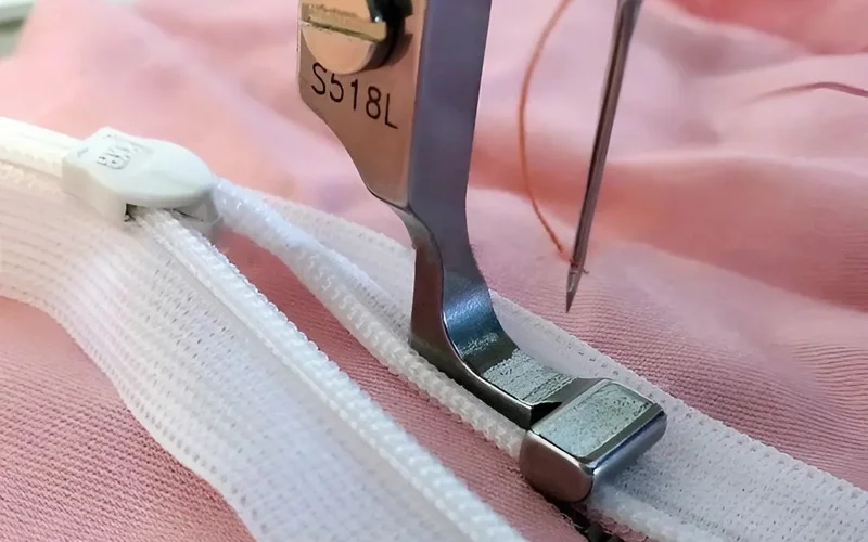 The zipper foot sews very close to raised edges, like the teeth of a zipper