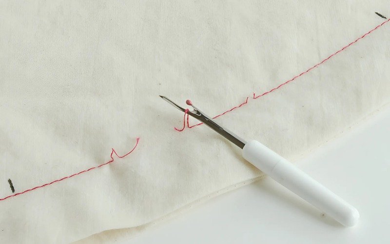 The method of Removing Stitches One by One is suitable for tricky areas or for thin fabric or fabric that might tear easily