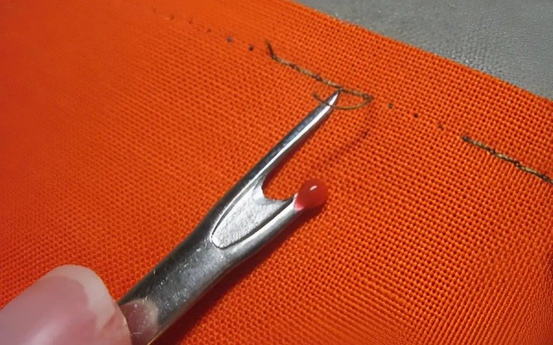 The fine point of a seam ripper helps pick out single stitches more easily than a scissor tip