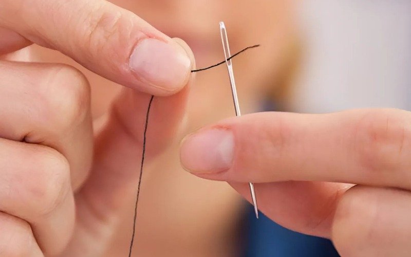 A sewing needle is a small tool; its job is to make a small hole in fabric. Then, it pulls thread through that hole to create stitches, which join pieces of fabric together or create decorations