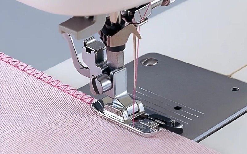 An overlock machine efficiently sews, trims, and finishes fabric edges in a single step, making it a very fast sewing machine and saving a lot of time