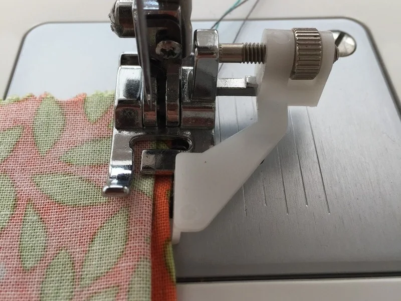 Close-up: Blind hem foot guiding fabric flawlessly.