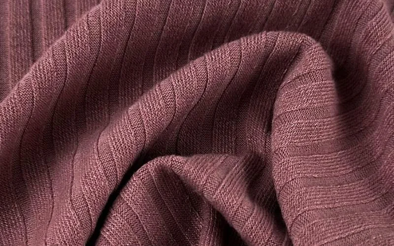 Knitted fabrics are made from one continuous thread looped together, similar to hand knitting