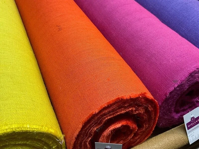 Bulk fabric rolls in consistent, vibrant shades.