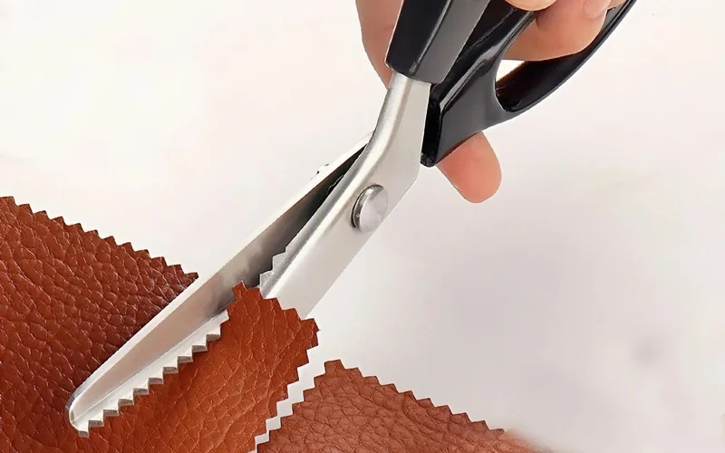 When pinking shears make a zigzag cut on fabric, they create many very short thread ends along the fabric edge. These tiny, short thread ends are much harder to pull loose