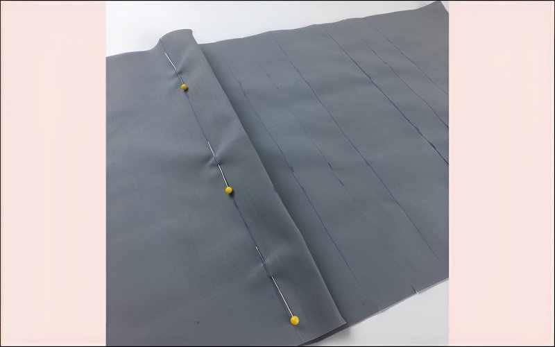 Wider Tucks, also called Broad Tucks, are made with a larger fold of fabric