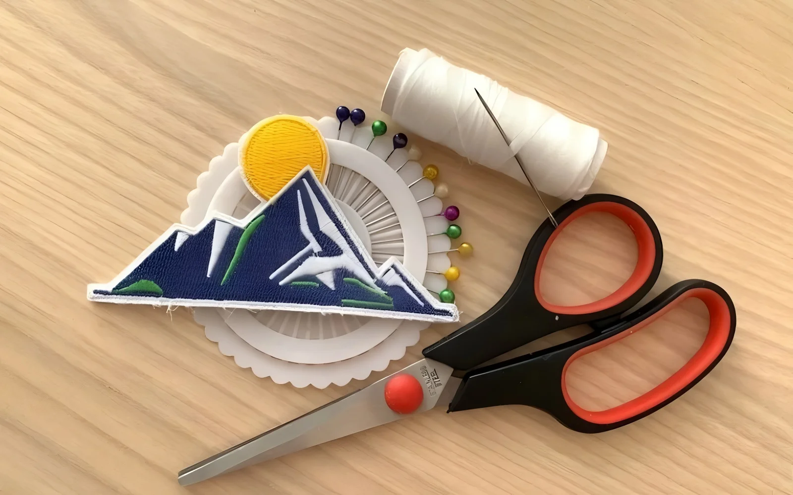 A sharp needle, strong polyester thread, and scissors are the essentials for a professional patch application